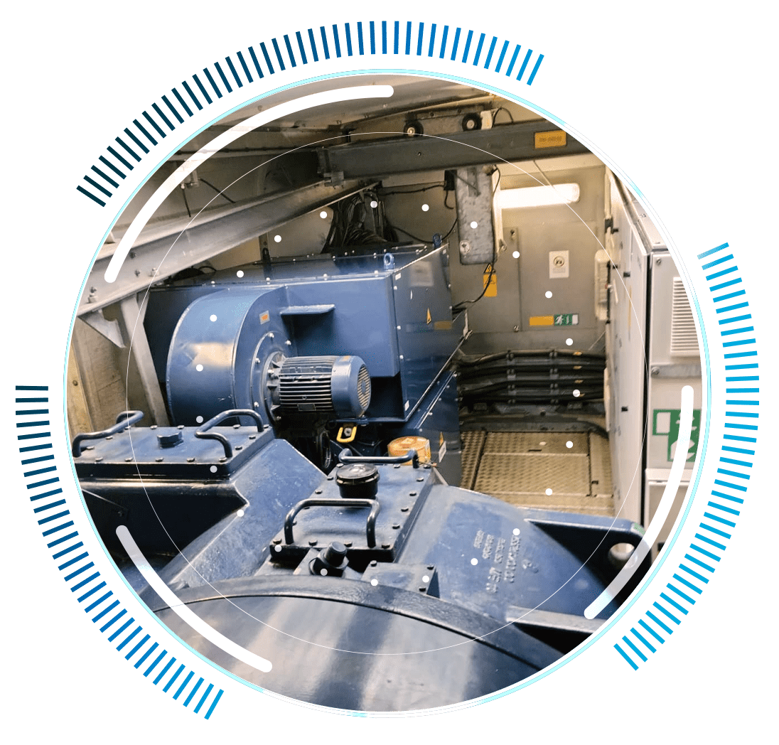skywings.com.pl - Large industrial machinery with blue components, motors, and cables is housed in a metallic enclosure—ideal for HSS-Lager-Austausch or Windturbinen-Service. Overlay graphics of blue lines and white dots add a technical look to the circular image. Wind Turbine Service & Maintenance, Windenergieanlagen-Service & Instandhaltung