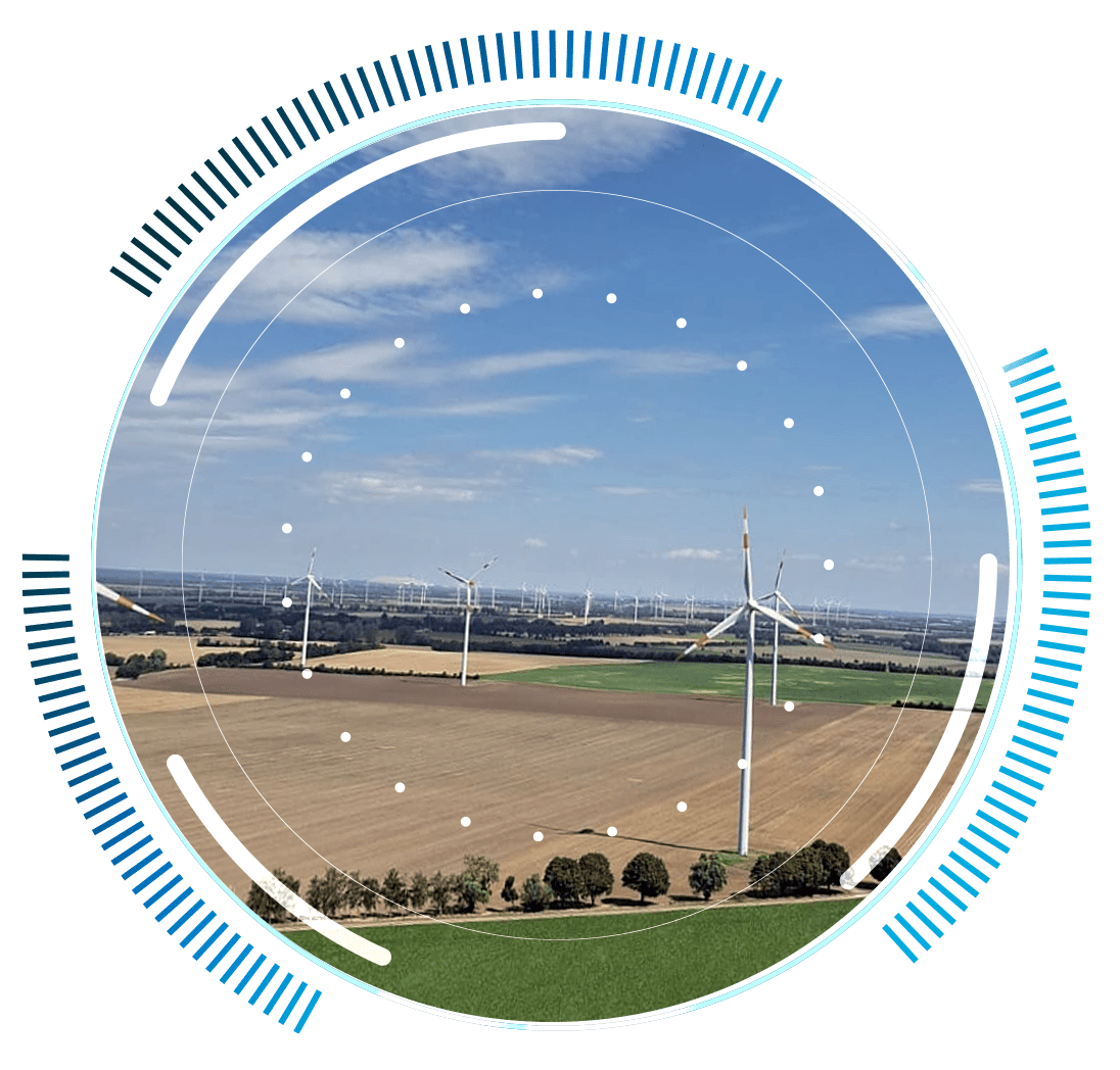 skywings.com.pl - Wind turbines in a large open field under a blue sky, viewed through a circular digital interface with blue and white graphic elements, highlight the importance of Windenergieanlagen-Wartung and Generatorlager-Wechsel for optimal performance. Wind Turbine Service & Maintenance, Windenergieanlagen-Service & Instandhaltung