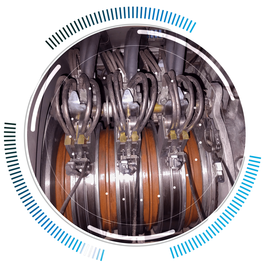 skywings.com.pl - Close-up of a mechanical assembly with three orange circular components, metal connectors, and black cables, surrounded by a blue and white digital overlay—ideal for showcasing HSS-Lager-Austausch or Vestas-Getriebe-Service in wind turbine service operations. Wind Turbine Service & Maintenance, Windenergieanlagen-Service & Instandhaltung