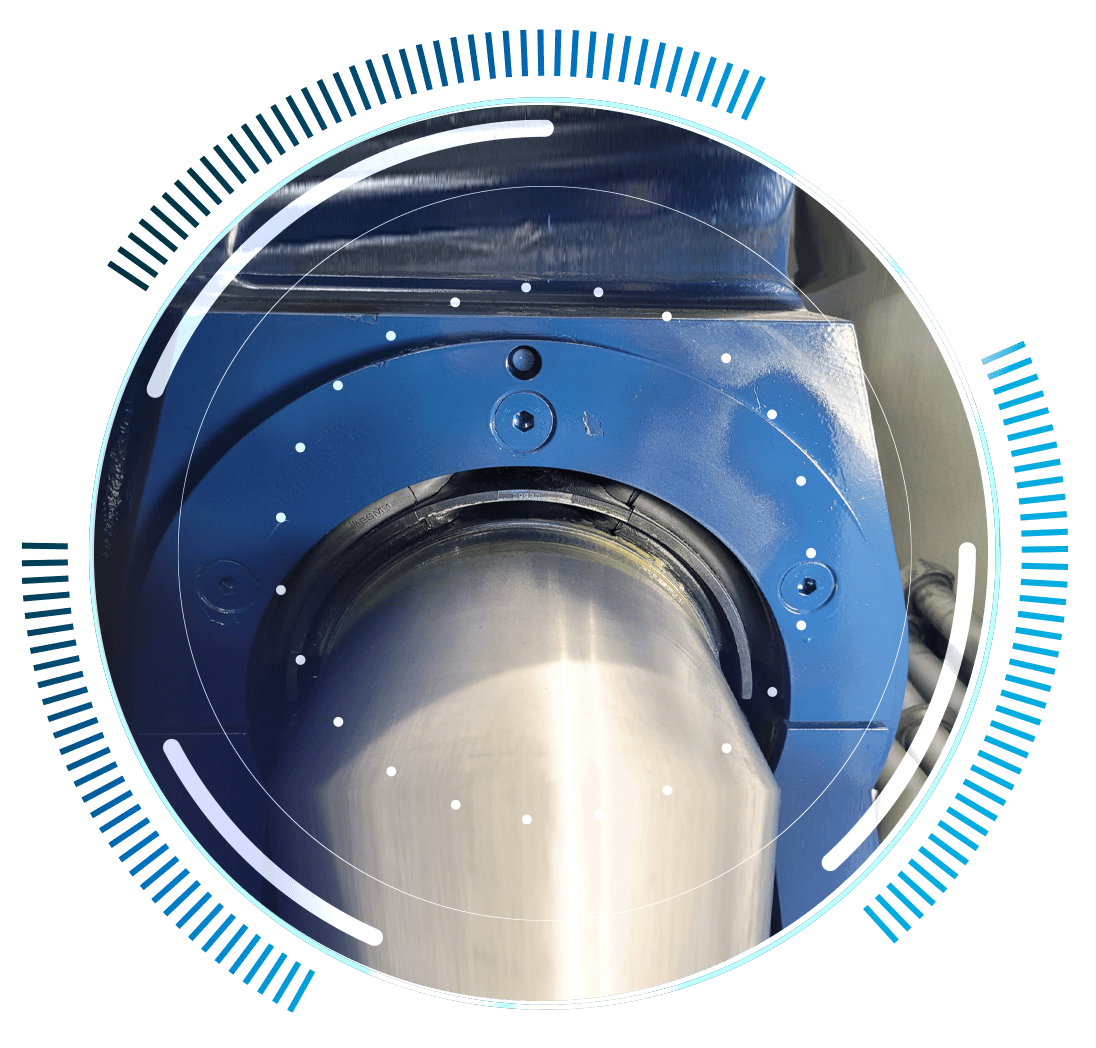 skywings.com.pl - Close-up of a metal cylindrical machine part housed in a blue casing, with a digital circular interface and blue indicator lines—ideal for showcasing hydraulic system service for wind turbines. Wind Turbine Service & Maintenance, Windenergieanlagen-Service & Instandhaltung
